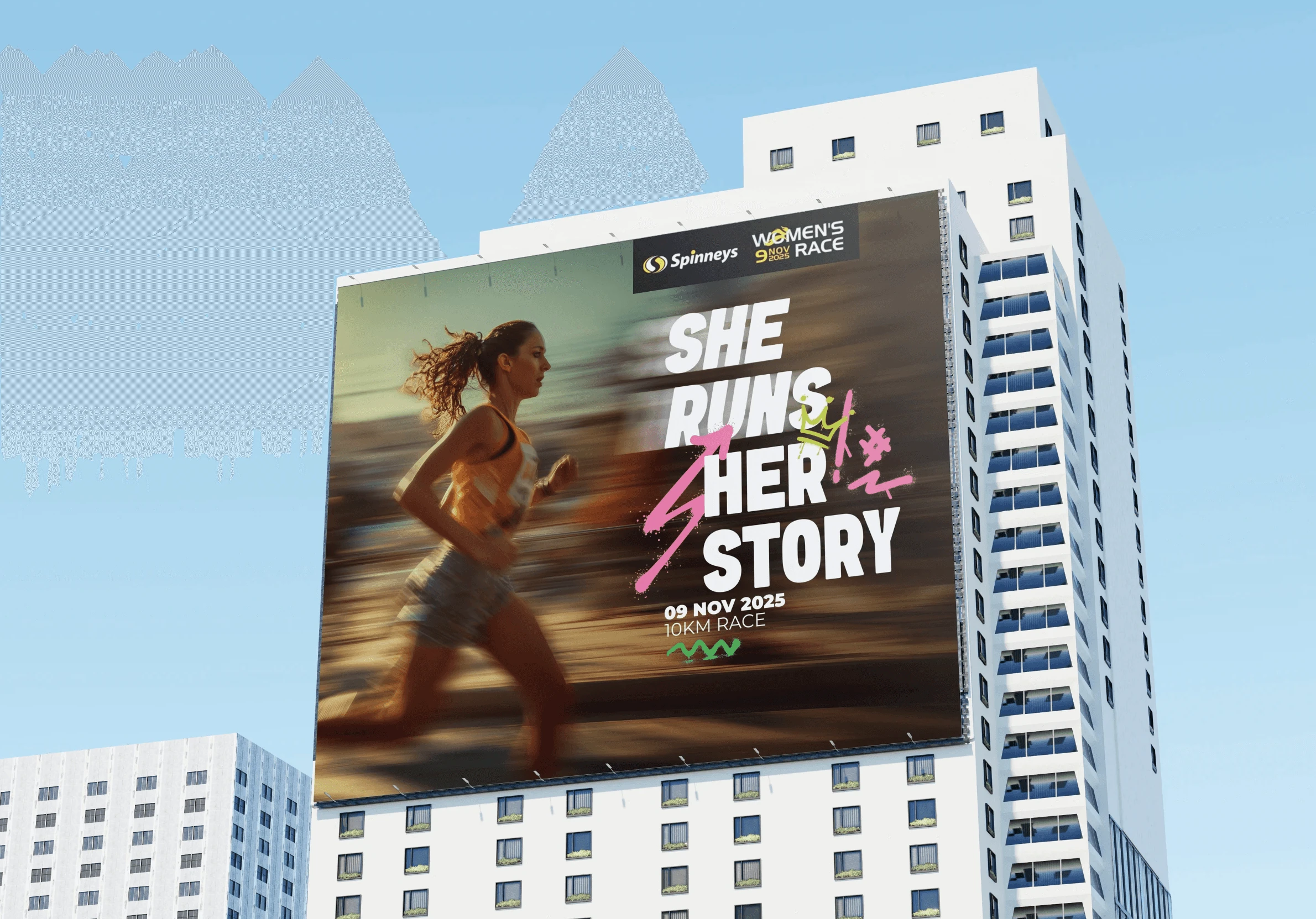 Spinneys Women’s Race campaign billboard on a city building, with the headline ‘She Runs Her Story’